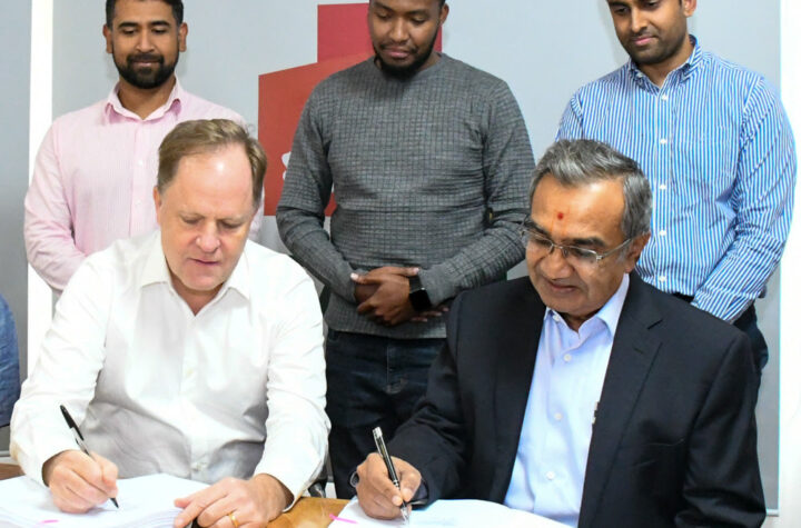 (L-R) Preston Mendenhall, Country Head, Kenya, at Rendeavour, the owner and developer of Tatu City, and Manji Kanji Raghwani, Managing Director, Laxmanbhai Construction, sign the contract. Looking on: Amit Joshi, Senior Project Manager, Tatu City, James Marumi, Legal Counsel, Tatu City, and Khusal Raghwani, Project Manager Laxmanbhai.-Newsline.co.ke